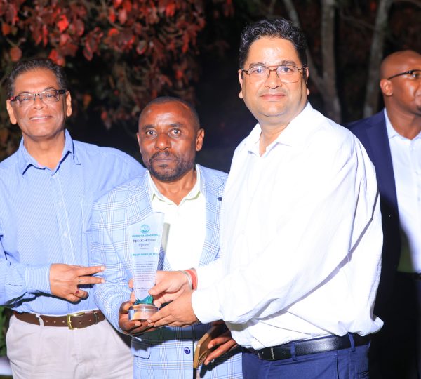A proud moment for McLeod Russel (U) Ltd representatives celebrating and showcasing their company's award at the event.