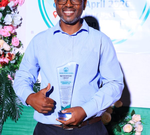 Celebrating excellence: One of our valued Association members Mr. Bomukama Albert proudly displaying the award received on behalf of Kyamuhunga Tea Company Ltd at the event.